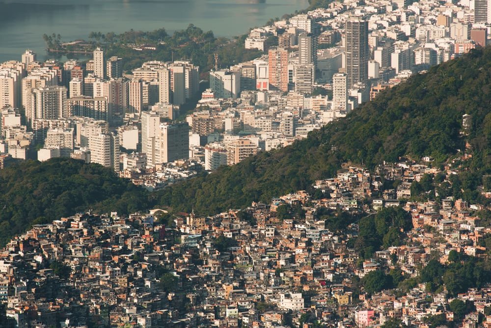 Aerial view contrasting dense neighbourhood area with adjacent apartment buildings, symbolising Urbanization and Construction Thailand.