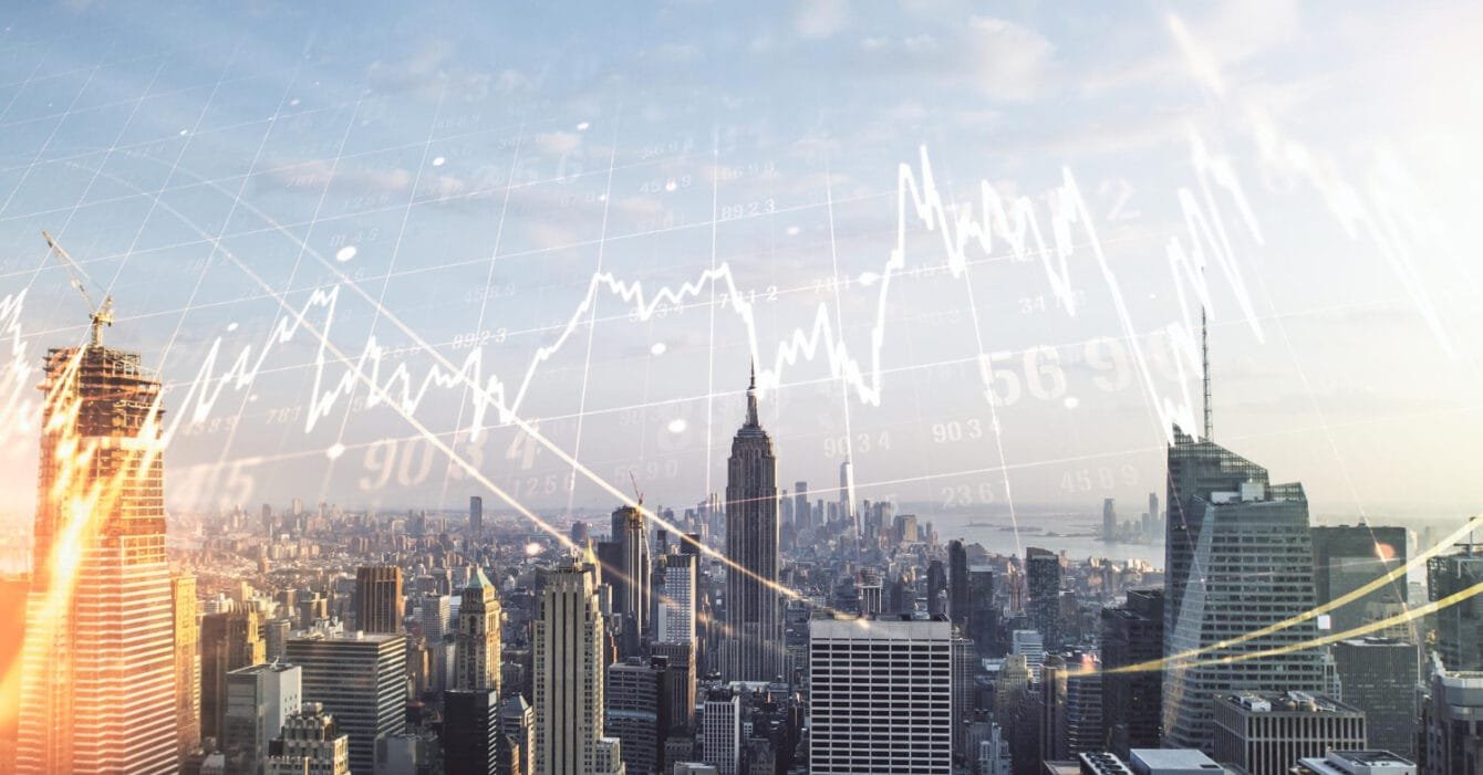 Thailand Public-Private Partnerships: City skyline with superimposed financial graphs indicating stock market activity.